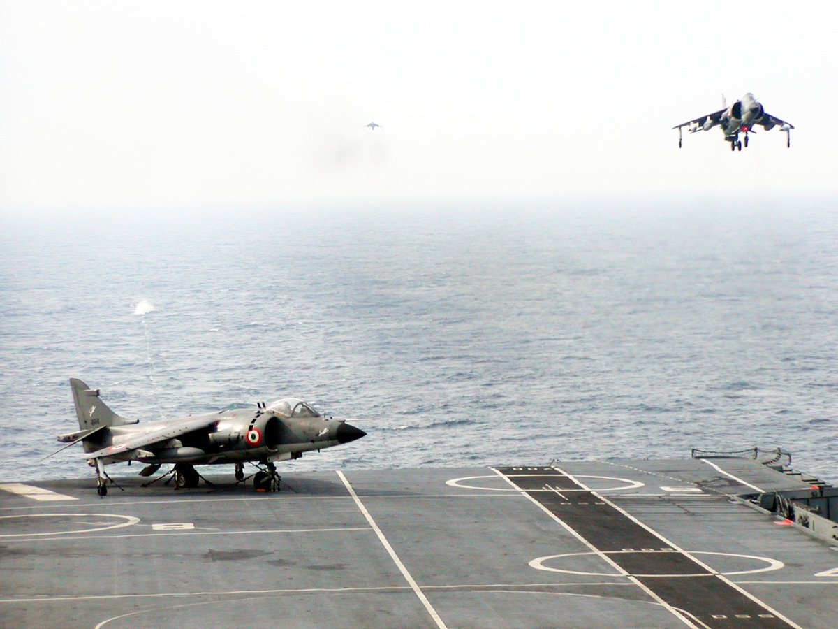 A Harrier heads back to Mother Ship even as another one keeps a watchful eye, with a third one lining up in the far distance!