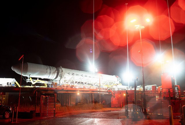 Antares rocket horizontal at night with bright lights