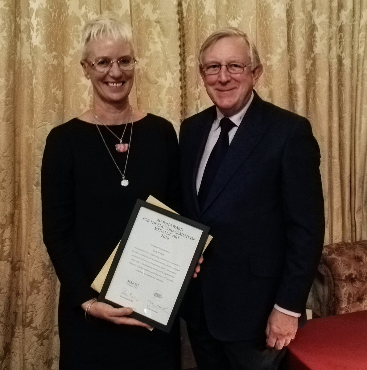 Nick Carter of the <a href="/MarshAwards/">Marsh Charitable Trust</a> presents the award for the encouragement of medallic art to Lucy Willow of <a href="/FalmouthUni/">Falmouth University</a>.  A deserving winner for all she has done to teach and inspire young medal-makers.  The Trust recognises the work of unsung heroes in a variety of fields.
