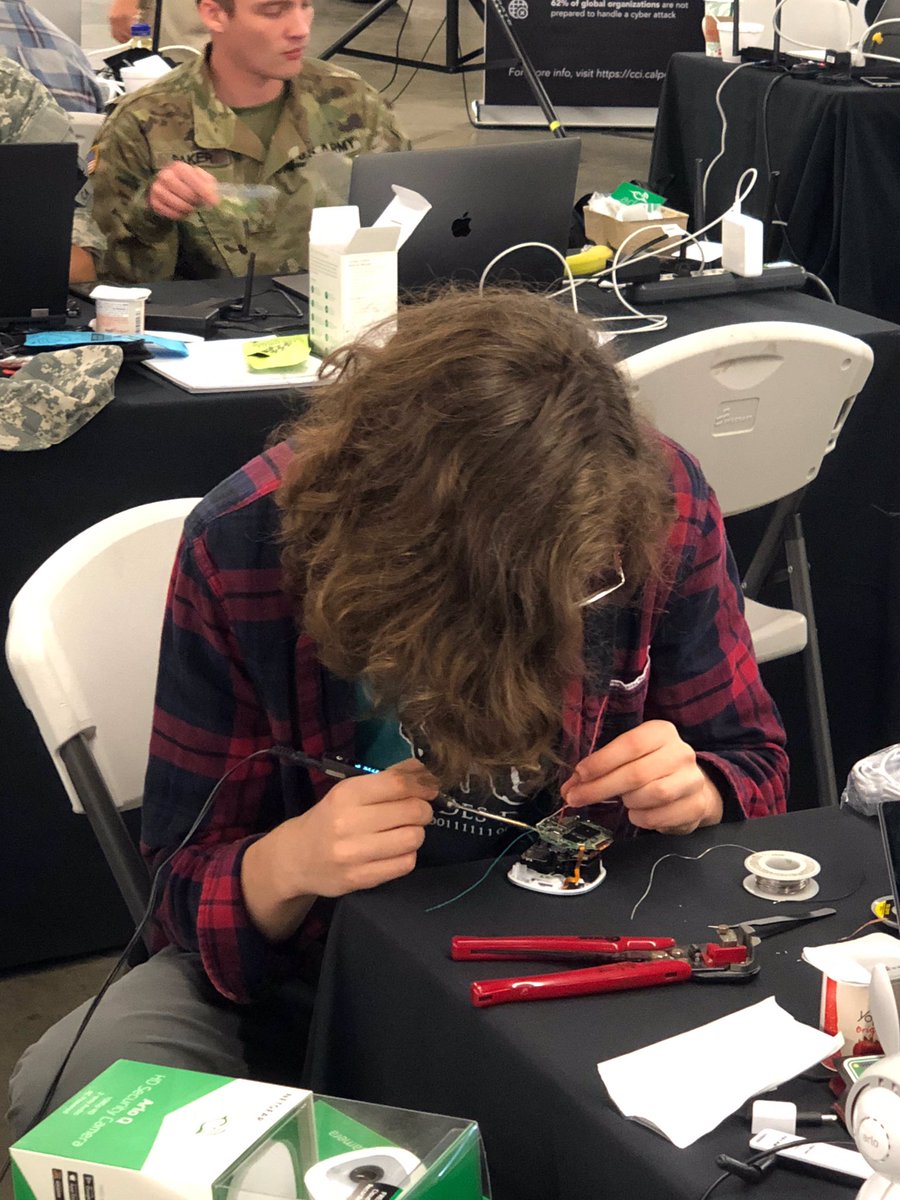 Bugcrowd's tweet photo. IoT hacking requires some intense concentration #BCBugBash #HackCampSLO with @ArloSmartHome https://t.co/6lH8398rPh