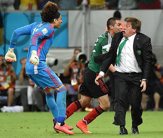 LETFootball's tweet image. Mexico's coach Miguel Herrera celebrating with his goalkeeper Guillermo Ochoa during their match against Croatia at the Pernambuco Arena in Recife, #WorldCup2014