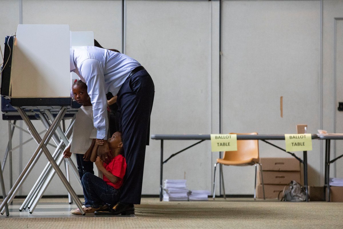 Mayor Andrew Gillum, who is running for governor as a Dem candidate, casts his vote with his kids Caroline and Jackson this morning. Caroline is looking at the camera, and Jackson sits underneath his dad, pulling down on his arm as Mayor Gillum votes. If he wins, he'll be the state’s first Democratic governor in two decades and the first Black governor of Florida.