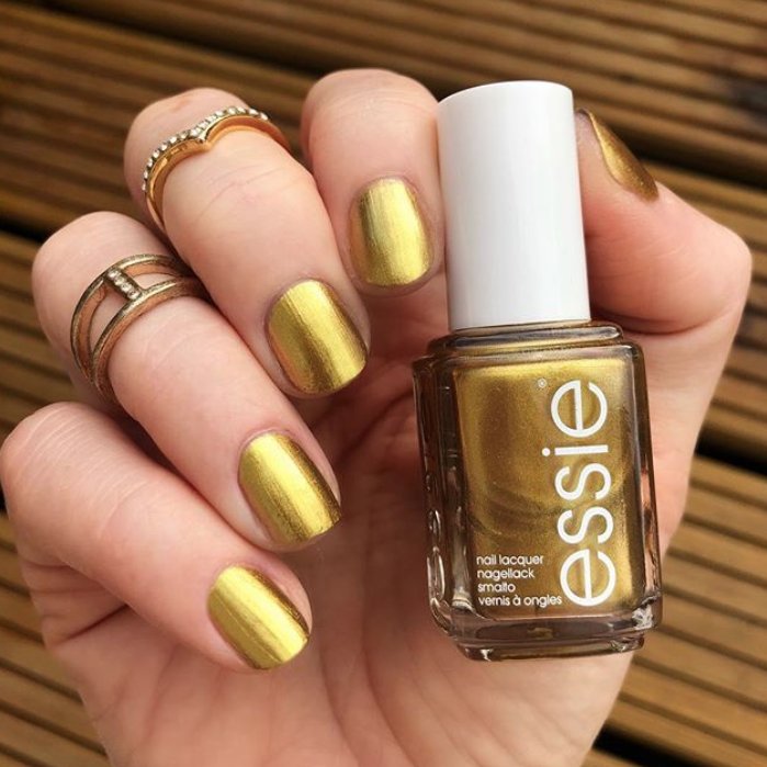 essie's tweet photo. it's about that time of year when we can't get enough of all gold everything ✨✨✨ @sundancegirl wears new #essiewinter2018 shade #millionmilehues https://t.co/v0ByEX2085