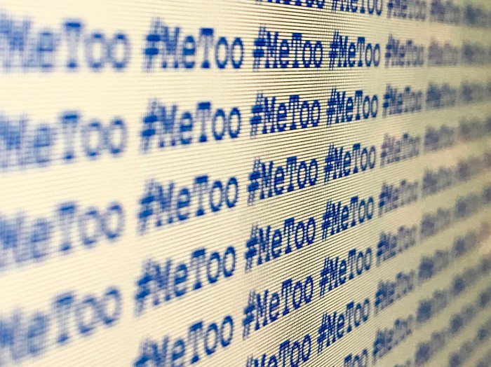 A computer screen showing #MeToo in blue text on a white background repeated over and over again