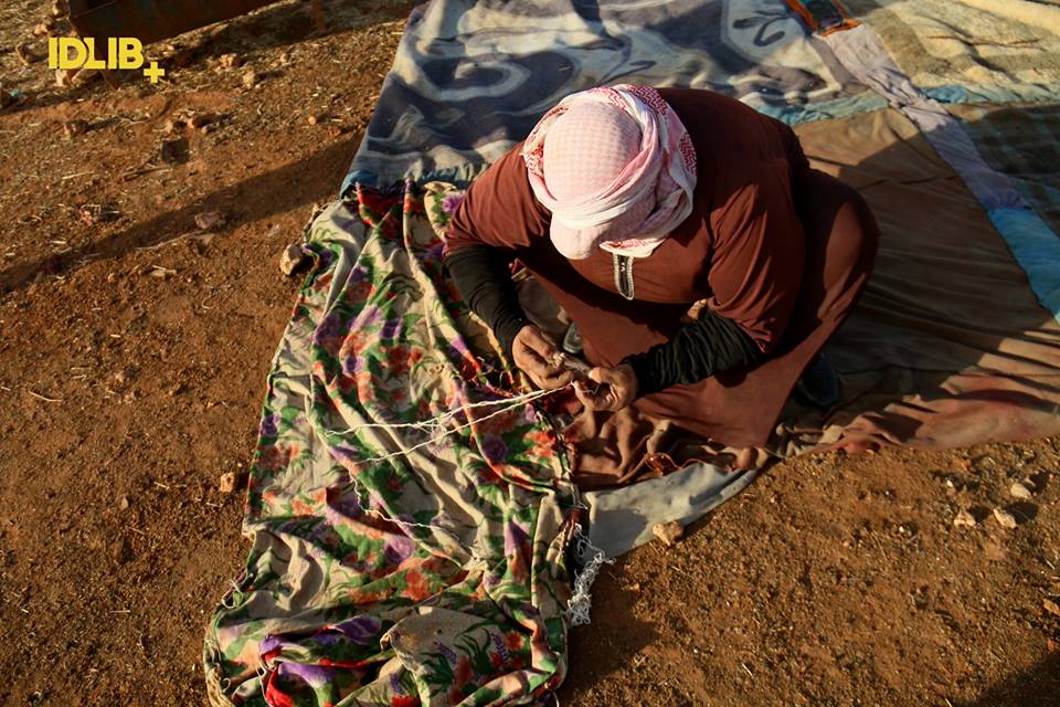 1962Wren's tweet photo. Watching your Mother sew your Home. #IDP Camp #MaraatalNuman #Idlib #Syria #save_them https://t.co/ERysObfn4M