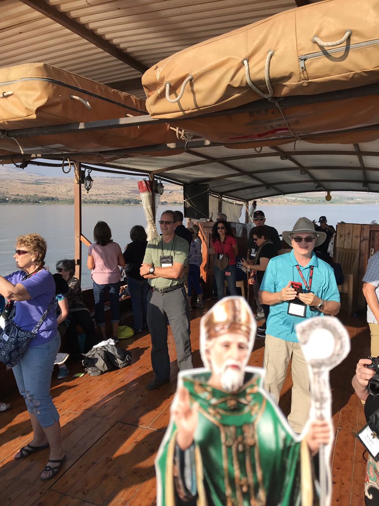 StPatSch's tweet photo. @PadreBrian and Flat St. Pat were busy tourists today!  They took a boat ride on the Sea if Galilee, visited the ancient city of Capernaum, Tabka the church of the multiplication of the loaves and fishes, and the home of Peter. #flatstpat  #stpatproud https://t.co/v5f3RUJFA6
