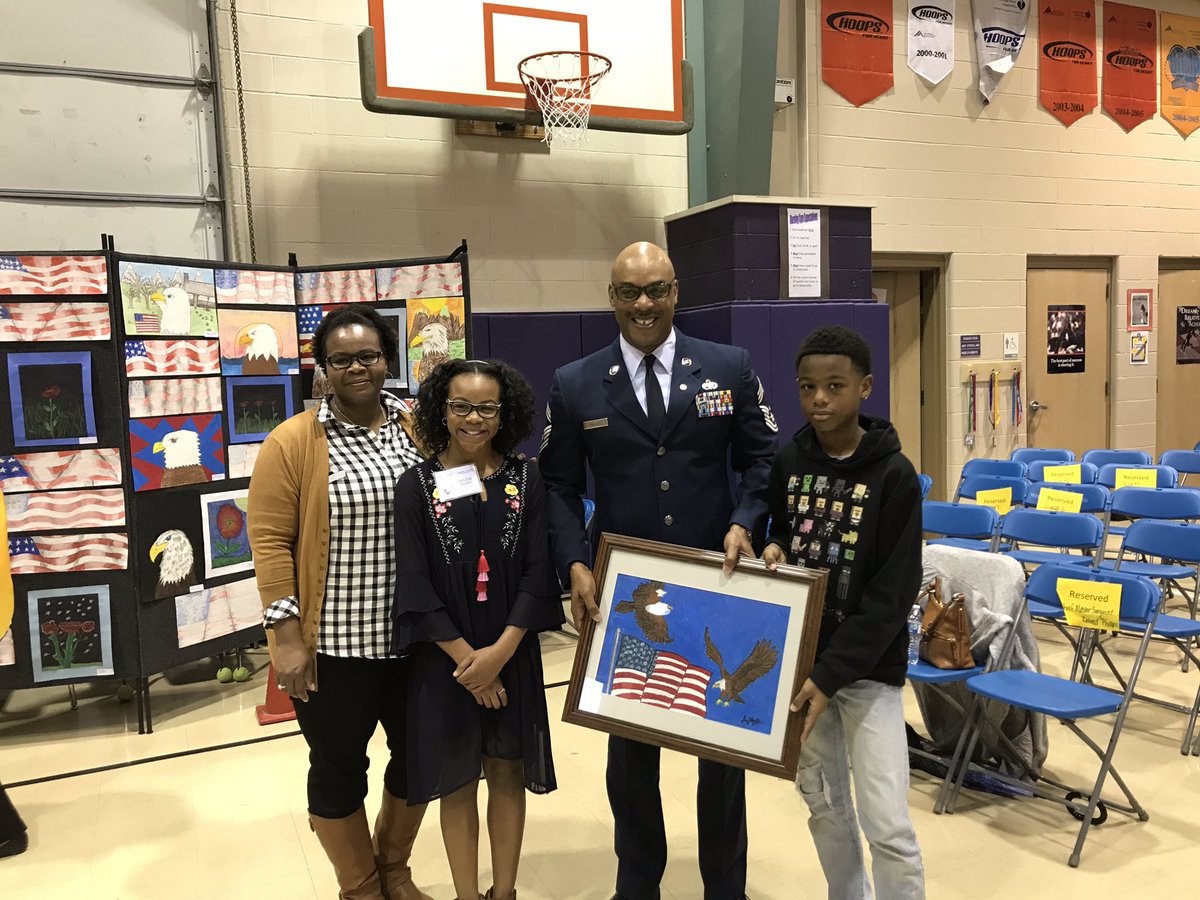 Chief Master Sargeant Phillips receiving original artwork from Dorian, the artist.  #VeteransDay2018 #TraitsOfAGraduate