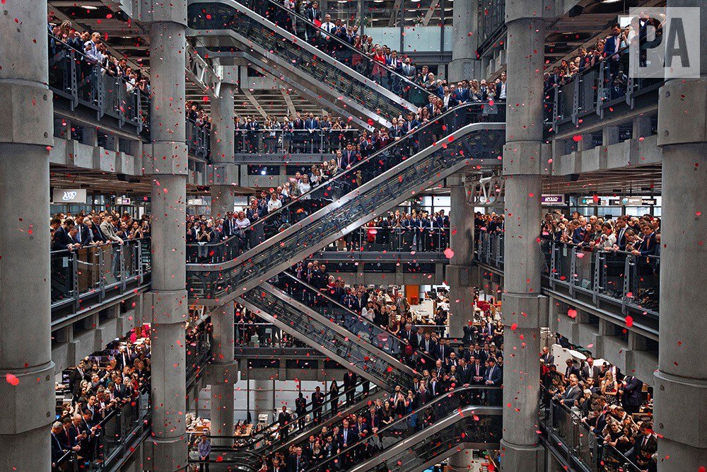 Poppies fall through the atrium of the Lloyd's of London building during its Armistice Day 2018 commemoration service #Armistice100 #Remembrance2018