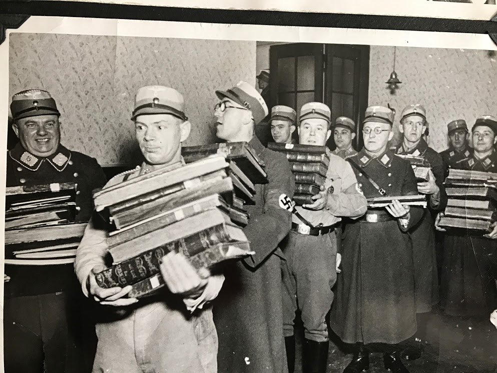 Here, some jolly Nazis stealing Jewish holy books, later to be burned.