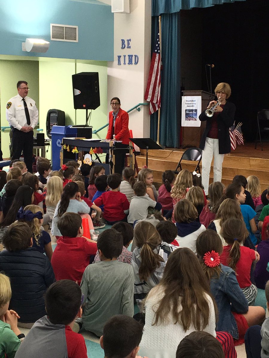 Professional trumpet player Louise Barranger is showing students how the trumpet is used in the military.