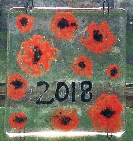 The children of Bibury Church of England Primary School - bibury.gloucs.sch.uk/web created their own memorial. Glass tiles featuring the remembrance poppy. Absolutely spectacular with the church and setting sun behind them. #WeWillRemember #Bibury #RemembranceDay2018 #Cotswolds