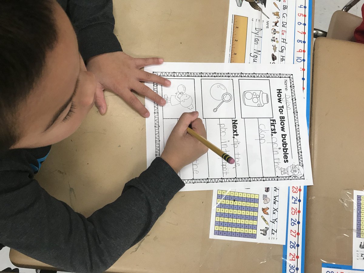 First graders study the steps to blow bubbles so they can teach someone how to do it!