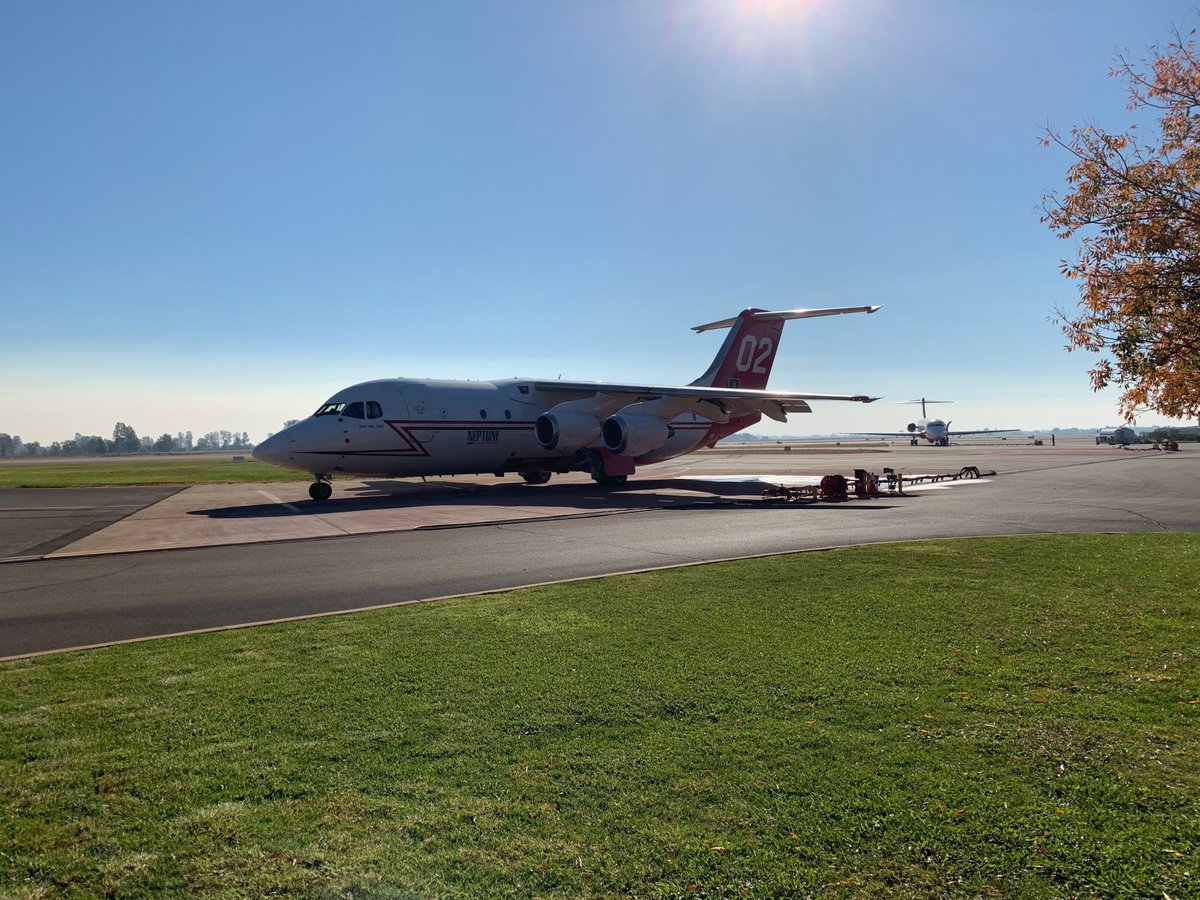 ShastaTrinityNF's tweet image. It was another busy day at the Redding Air Attack Base,  Earlier today, Tanker 02, in the forefront and Tanker 105 in the rear of the photo, both take on a load of retardant en route to support #CampFire firefighting operations. #CAWildfire, #ReddingAirAttackBase