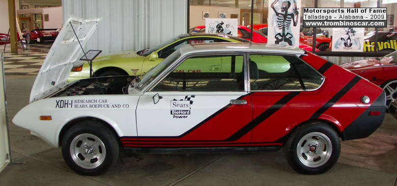 Sears automobiles made an EV in 1977 to celebrate the success of their 'Diehard' car batteries - it had a 100mi range and a top speed of 70mph and generally looks like a quite cool rally car. It lives in a museum in Alabama now.