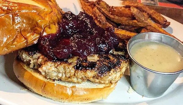 Tired of your leftovers but still wishing it was Thanksgiving?  You still have a few days to get a Thanksgiving Turkey Burger.  Hand-ground turkey infused with sage stuffing and topped with cranberry sauce. Served with turkey gravy and pumpkin-spiced sweet potato fries.