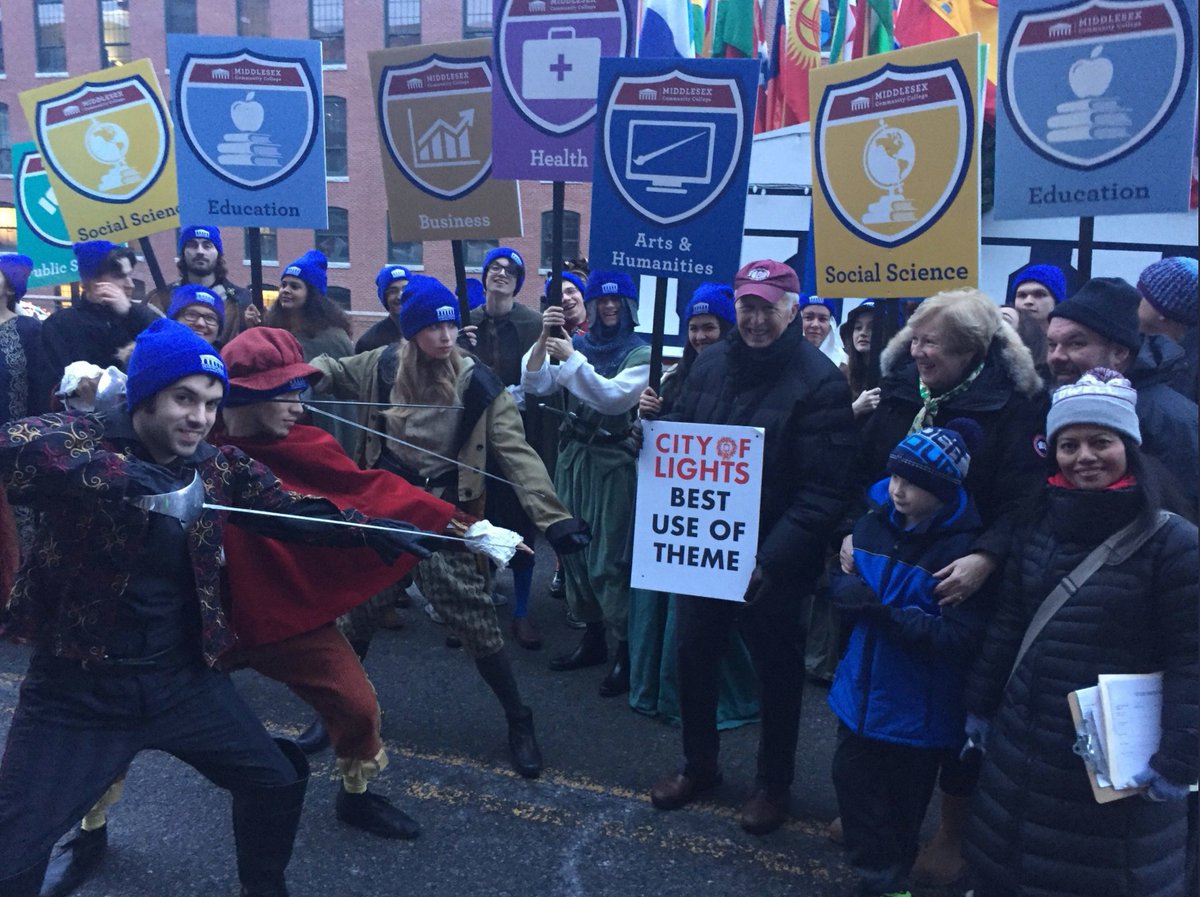 middlesex_cc's tweet photo. Last weekend, MCC participated in @CityofLowellMA's 30th Annual City Of Lights Holiday Parade, winning the Best Use of Theme award – our first prize! Students and faculty dressed up as characters from Shakespeare's "Romeo and Juliet," complete with sword fighting! #myMCC #MCCpath https://t.co/wBCBI1z9wE