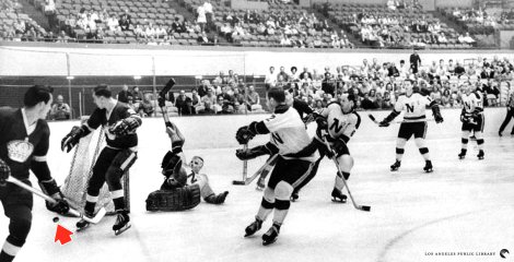  Minnesota North Stars goalie Gary Baumann sprawls awkwardly on ice at Long Beach Arena after narrowly deflecting goal attempt by Los Angeles Kings last night