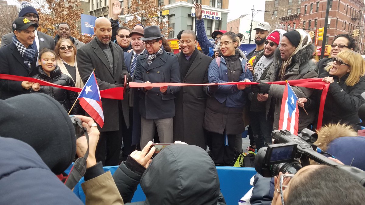 People including DOT Bronx Commissioner Nivardo Lopez, Bronx Borough President Ruben Diaz Jr, and Councilman Ydanis Rodriguez cut a ribbon in Roberto Clemente Plaza.