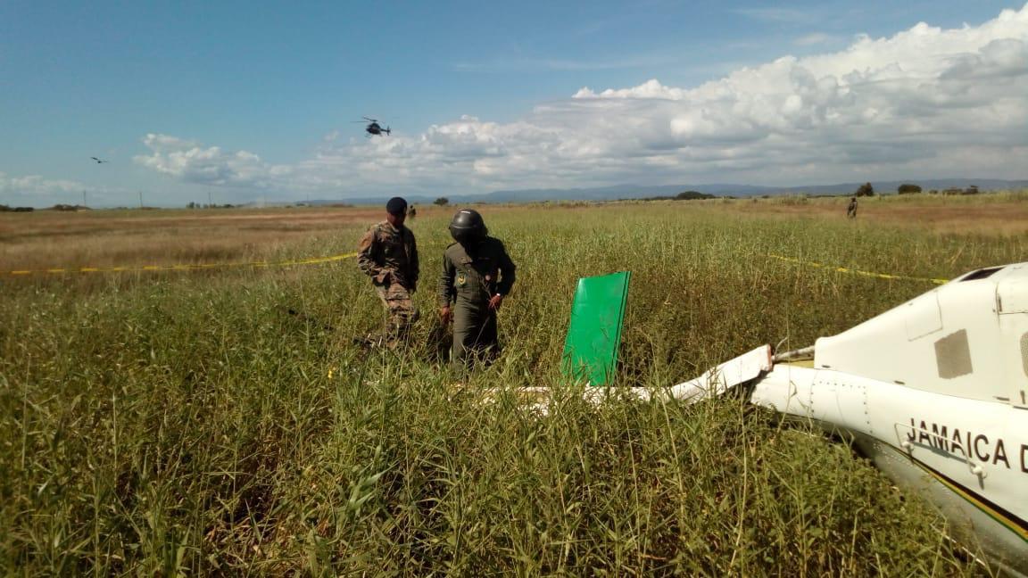 JamaicaGleaner's tweet photo. PHOTOS: These contributed photos show the wrecked @JDFSoldier helicopter after it crash-landed near the Dunbeholden main road in St Catherine. https://t.co/vX2kLE3HMQ