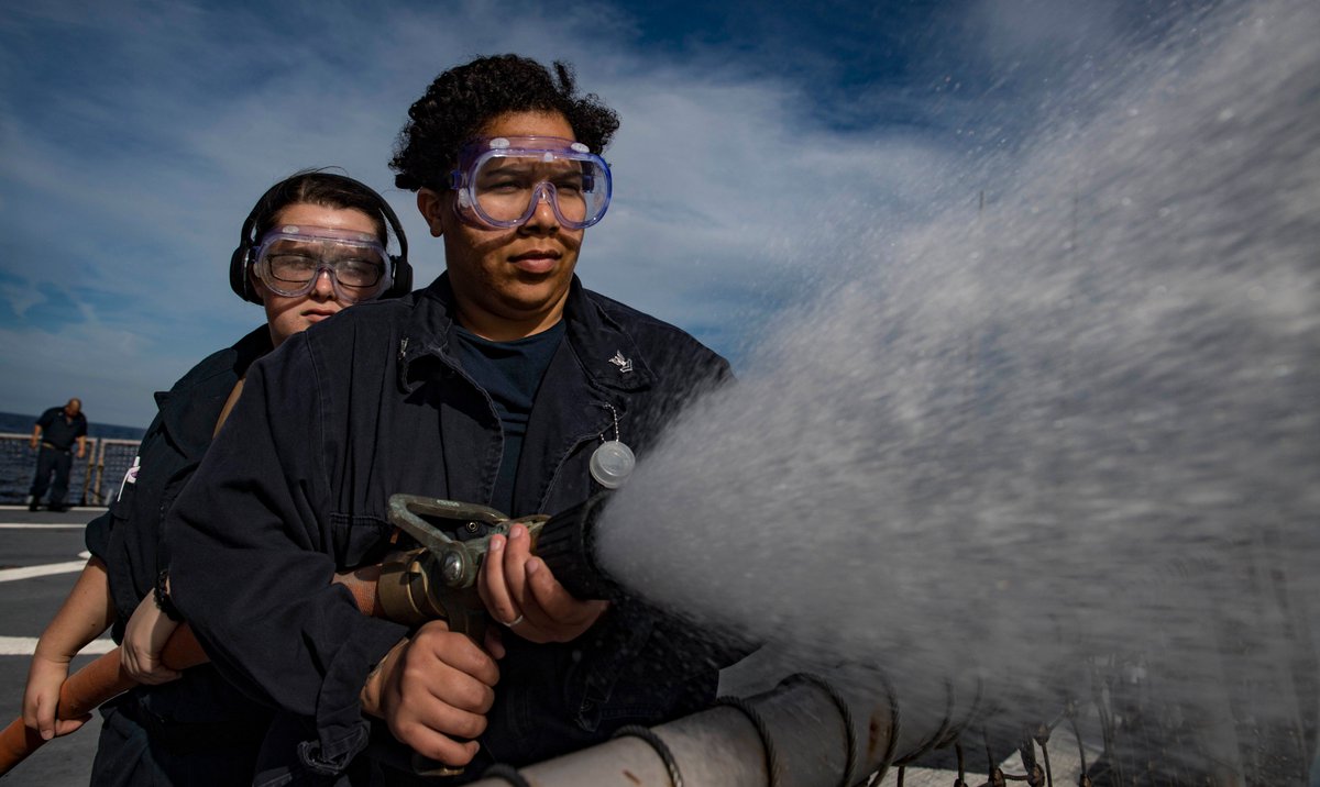 USNavyEurope's tweet photo. #GunnersMate Seaman Alexandria Kay, left, and #FireControlman 2nd Class Jeniva Fleming use a firehose to flush a weapons magazine sprinkler system aboard #USSCarney (DDG 64) Nov. 14, 2018. #ReadyForces #DDG #TrainingDay https://t.co/jH1AWmvhkU