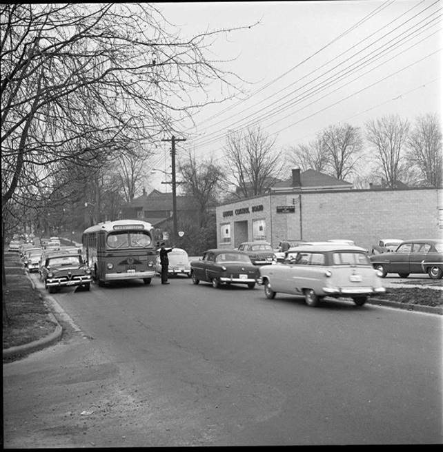 Give us a like if you remember when buses looked like this! #TBT to 1956. In this photo, the bus is travelling on Wellington Rd., south of Grand, while a police officer directs traffic out front of the liquor store. (Source Western Archives, London Free Press) #ldnbrt #ldnont