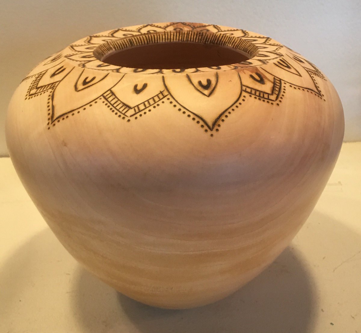 WebmasterBoston's tweet photo. Bradford pear hollow form about 12” tall with pyro mandala design around rim. #woodturning #hollowform #handmade https://t.co/jC3RA35sR4