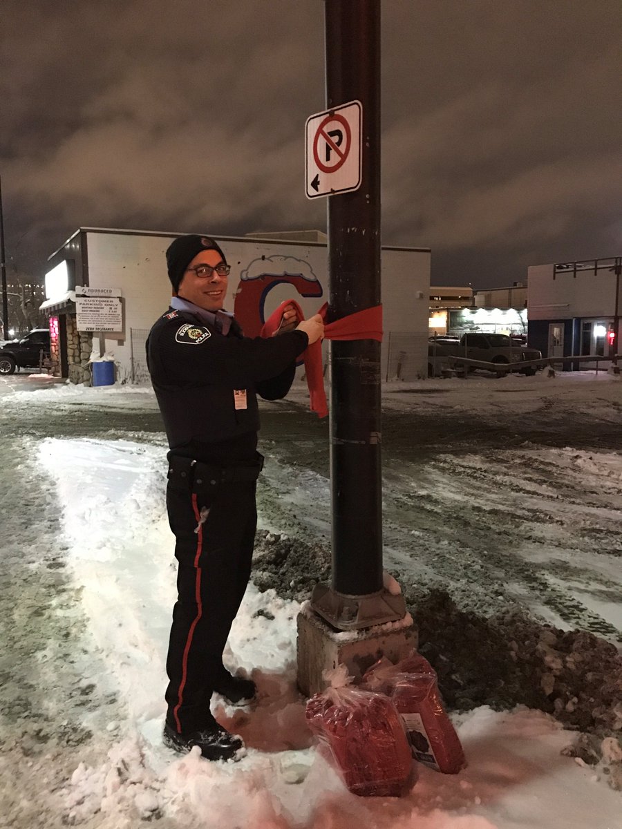 SudburyPolice's tweet photo. GSPS Community Response Unit and Auxiliary members helped distribute 200 scarves tonight for The Red Scarf Campaign - HIV Awareness Week. #BundleUpInRed ^vt https://t.co/joBWZBcSP5