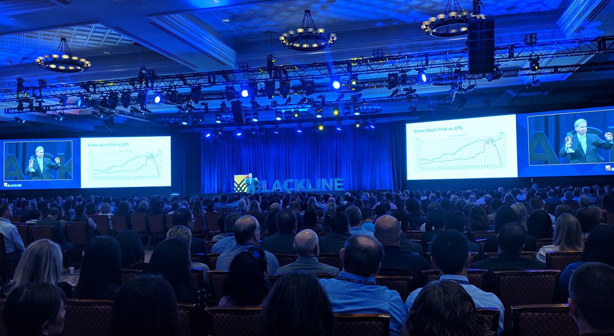 BlackLine's tweet photo. On stage at InTheBlack, Former Enron CFO Andrew Fastow holds his 'CFO of the Year' award in one hand and his inmate ID card in the other. See takeaways from his keynote: https://t.co/RpfRV0t8nm #ITB18 #Trustisinthebalance #finance #ethics #accounting #tech #financetransformation https://t.co/piZ5zXqGMg