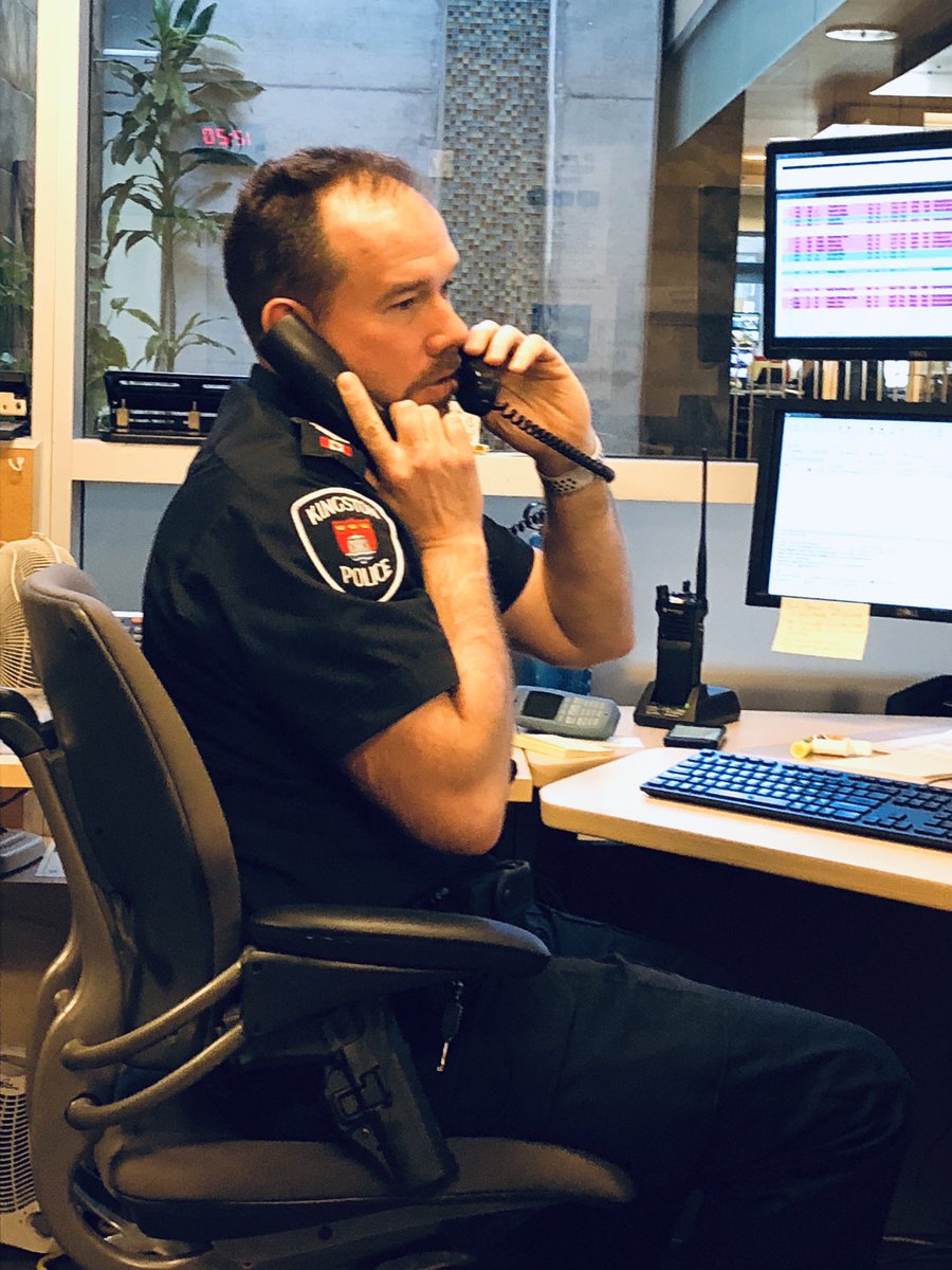 SgtKoopman's tweet photo. I have a sneaky S/Sgt who quickly snapped this on day shift at the Watch Commanderโs desk. A phone on each ear, a 3rd portable on the desk, a radio, 4 regular monitors and 2 more for security cameras. I got this! #multitasking101 ๐ https://t.co/W17o1VhErd
