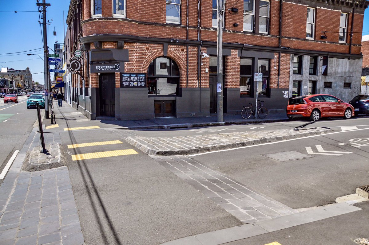 modacitylife's tweet photo. Rather than pay lip service to pedestrian safety, some cities are fixing their car-first street design. On Melbourne’s Brunswick Street, the raised footpath continues across each intersection, so drivers—as trespassers—have to move up onto the walking space (and back down again). https://t.co/b7gbaTt2WR