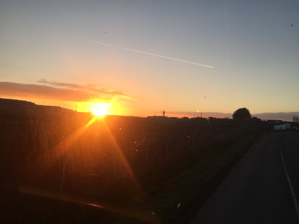 johnofladublin's tweet photo. The setting sun this evening over @DublinAirport taken from the top deck of the @dublinbusnews #DB102 - spot the new @IAApress control tower! https://t.co/4rbza5NcbX