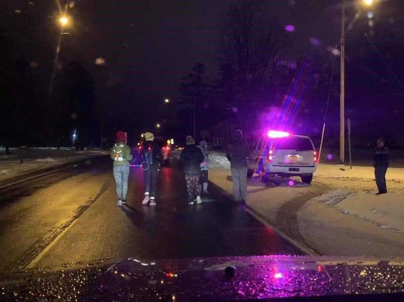 SUNYPotsdamPD's tweet photo. The 110 Mile National Adoption Day Run traveled through Potsdam last night. Runner Jess Hurlbut was briefly joined by our own Lt Ashley on a chilly and slippery night for a great cause. Read more about National Adoption Day at: https://t.co/J9kElAfLkc https://t.co/eM3i55NwDW