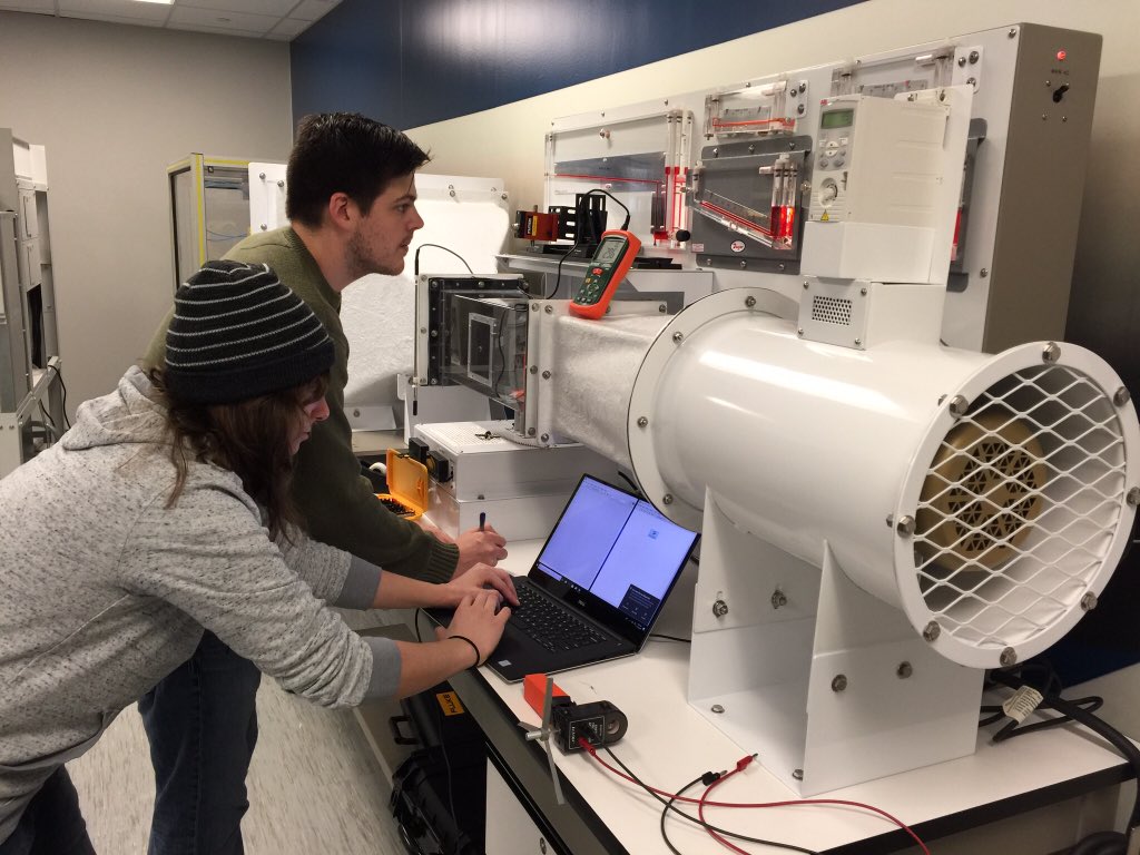 SHSUEngrTech's tweet photo. #SHSUEngTech seniors are testing a small-scaled wind turbine unit under extreme wind speed values in a wind tunnel; also improving operation using #LabVIEW DAQ @SamHoustonState @WindEnergyPower @TXWindEnergyInt https://t.co/BeQJZgFsZu