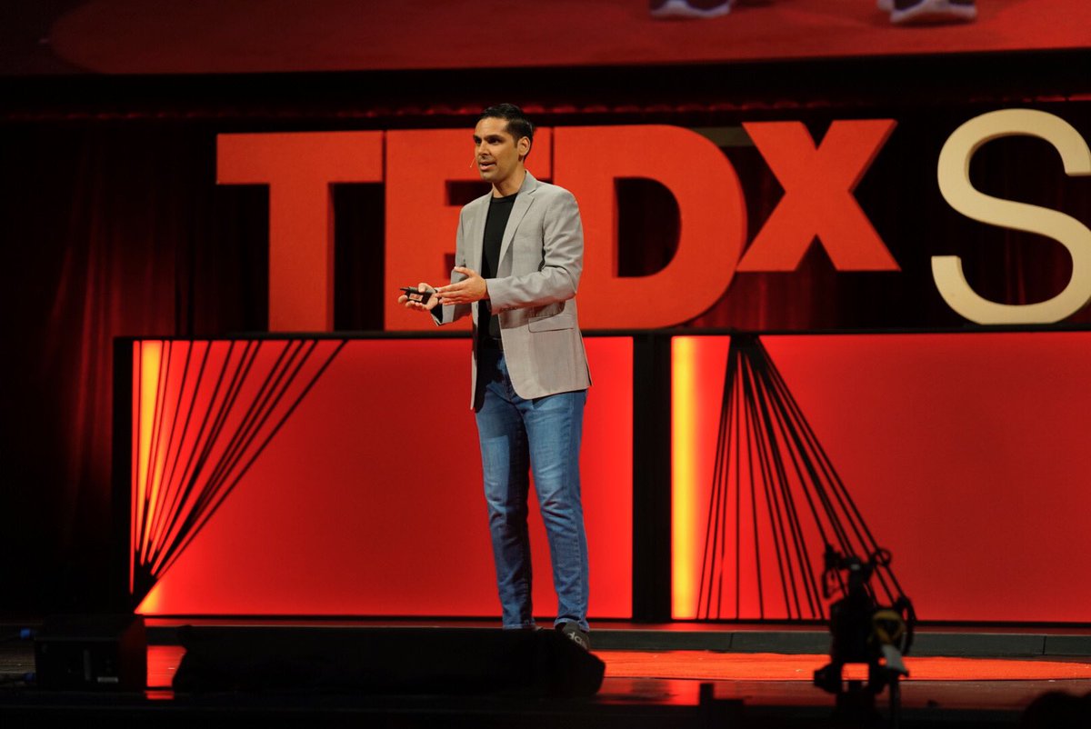 Anirudh Koul in front of a giant TEDx Seattle logo