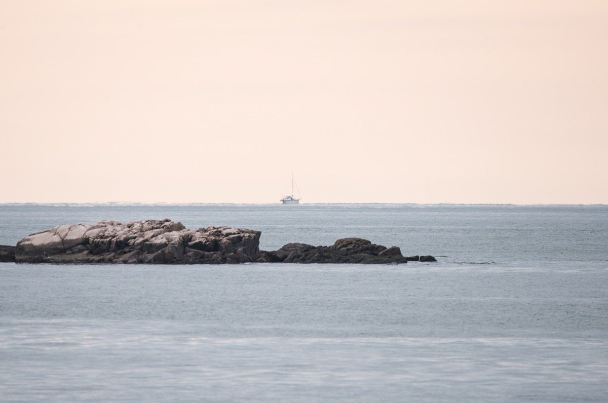 OK so here's a little demonstration of how you can directly observe the curvature of the Earth, thanks to the ocean and boats with tall masts. I took this shot today at 12:44 p.m. from Little Compton, RI looking south. It was shot at 600mm with a Nikon D810 from atop a wall.
