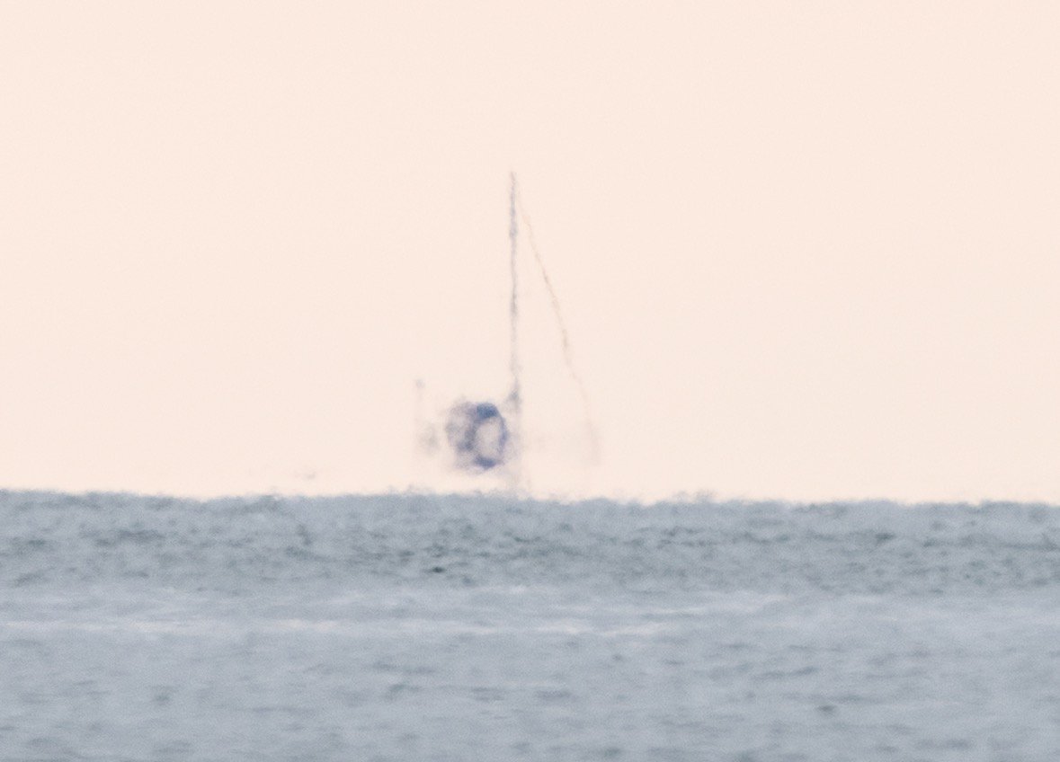 When I zoom in even further digitally there's a lot of refraction through several miles of air between me and the boat but this is the difference a couple of feet of elevation makes on my end.