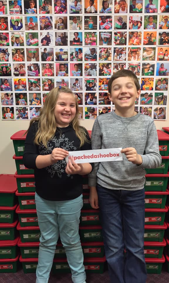 Jonathan and Sophia are tickled to help pack shoe boxes for Operation Christmas Child #ipackedashoebox