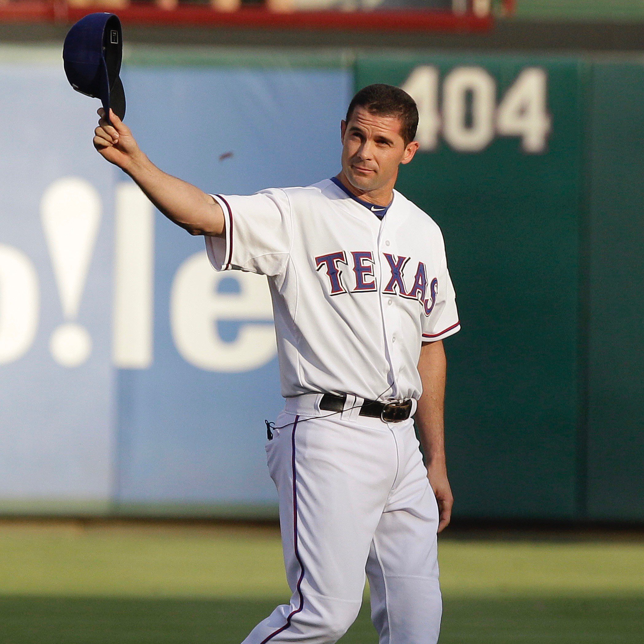 Texas Rangers' Michael Young, right, reaches up to congratulate