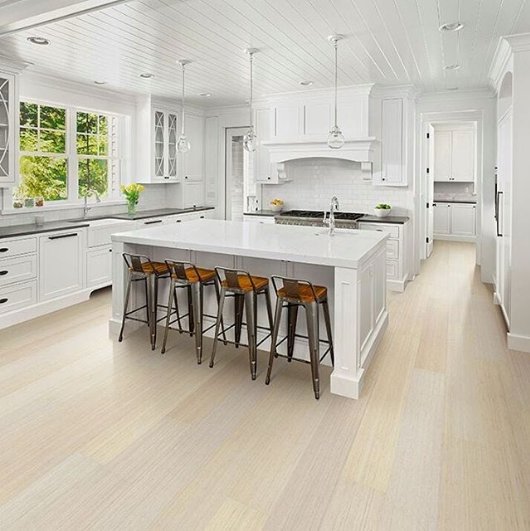 We love the way our Pureform - Hughes bamboo floors add a blend of classic and contemporary styles in this immaculate kitchen! They are also durable, dent-resistant, and available in extra-long planks for fashion-forward design.