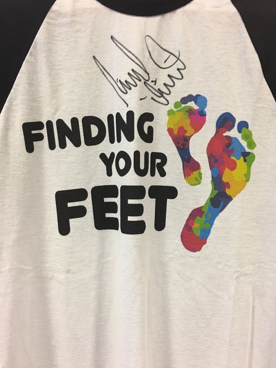 The finding your feet t-shirt.  Two colourful foot prints and the finding your feet text black on white.