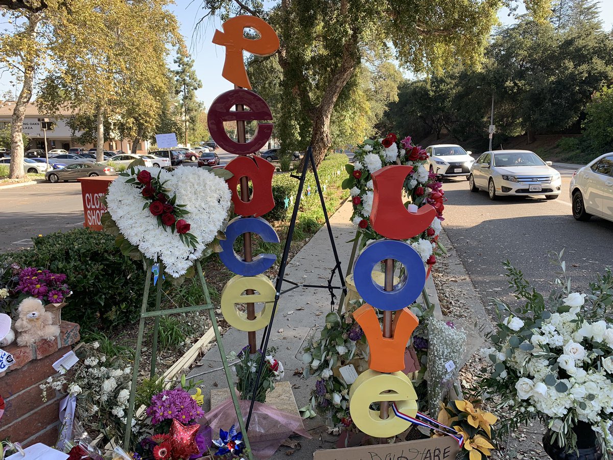 Mike___Harris's tweet image. A steady stream of people, some teary-eyed, many taking cell phone pics, are stopping by the huge community memorial for the victims of the #BorderlineShooting at corner of Moorpark Road and Rolling Oaks Drive  near the #ThousandOaks bar where the mass shooting took place Nov. 7
