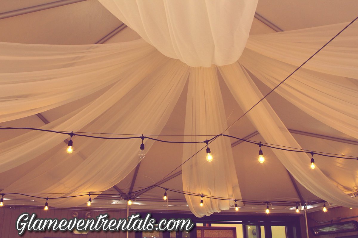 Mbryzia's tweet photo. It was so much fun creating this warm &amp; cozy starburst ceiling drape look for Mickey Spillane’s Pub patio tent! Glameventrentals at it again #design #decor #partydecorations #backdrops #chiavarichairs #ghostchairs #foldingchairs #ghosttable #events #eventplanning https://t.co/bqYg17lgIQ