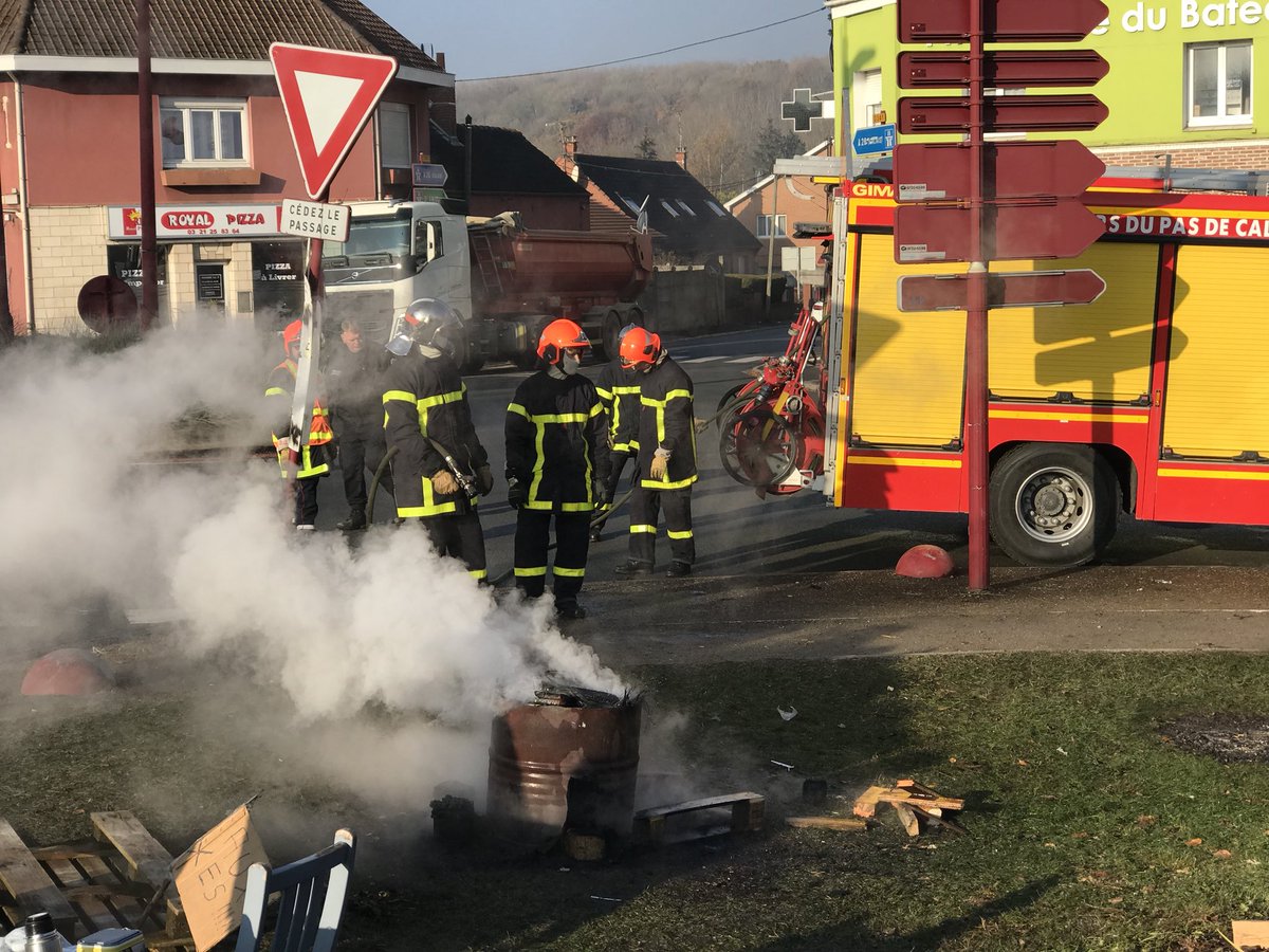RumuVdn's tweet photo. Un pneu jeté dans le brasero a provoqué l’intervention des pompiers au rond-point du Bateau. « Si vous voulez vous réchauffer, prenez un barbecue au gaz, ça ne fait pas de flammes », conseille un policier... #GiletsJaunes #CalonneRicouart https://t.co/hf6c4eZD03
