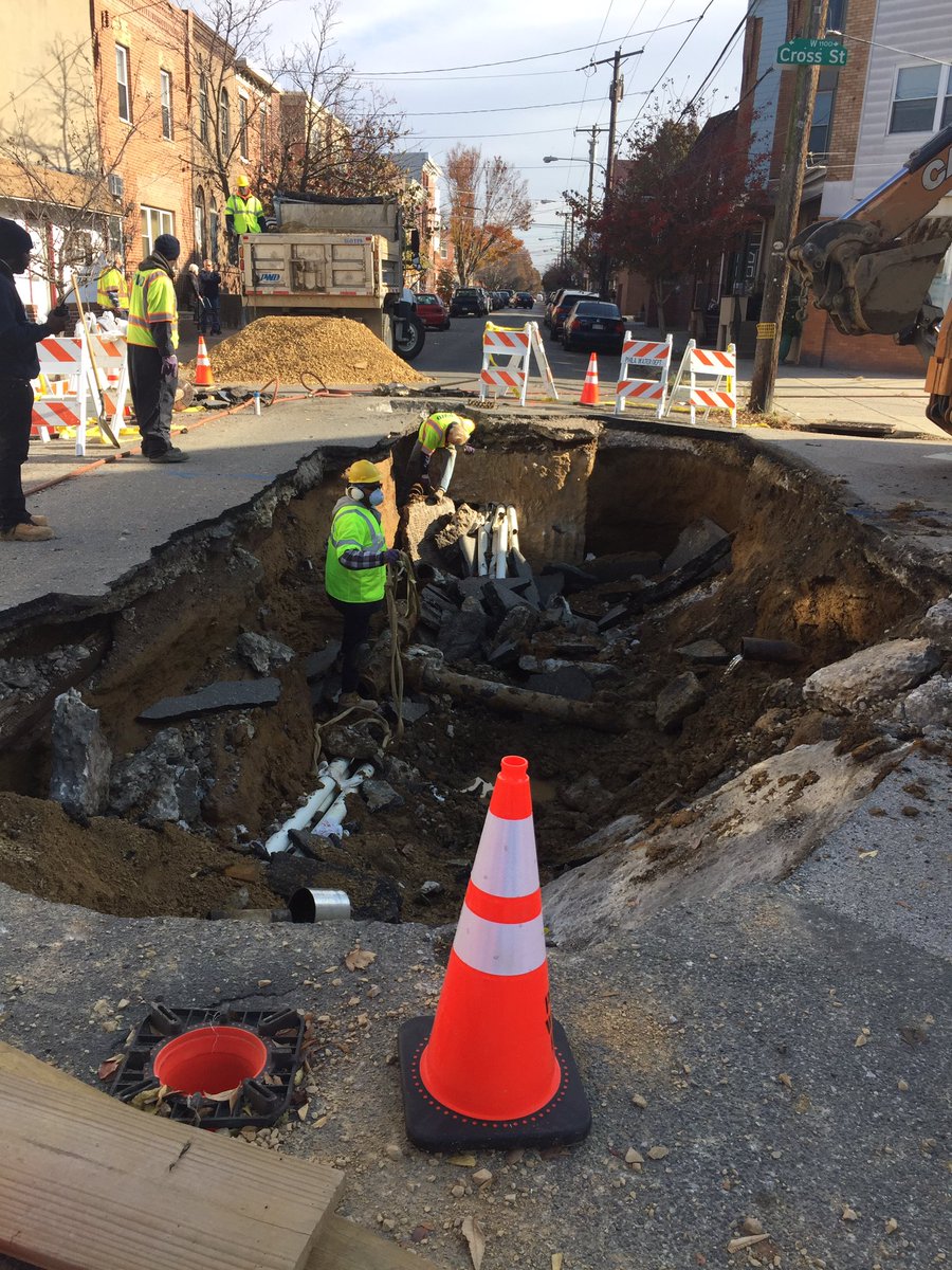 At 12th and Dickinson ..a massive sinkhole..the result of ruptured sewer line..triggering a large water main break overnite..60 customers without water service ..workers hope to restore it this evening..sinkhole problem could last a month