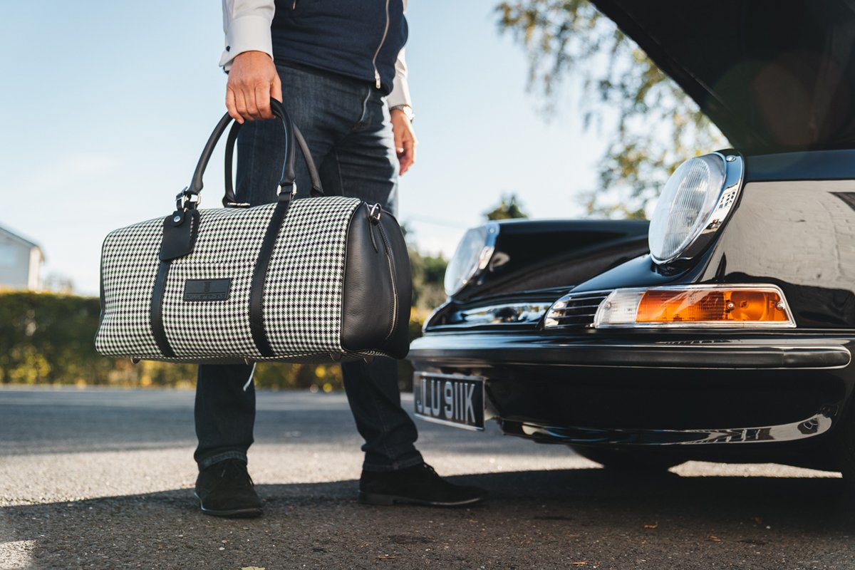 PaulStephens911's tweet photo. Finished in black leather and a bespoke houndstooth, a fabric synonymous with Porsche 911s. The Clubsport Holdall combines our ethos of detail-driven luxury and Porsche 911 heritage. https://t.co/8jd1GqCgHm https://t.co/b5omsHkzhm