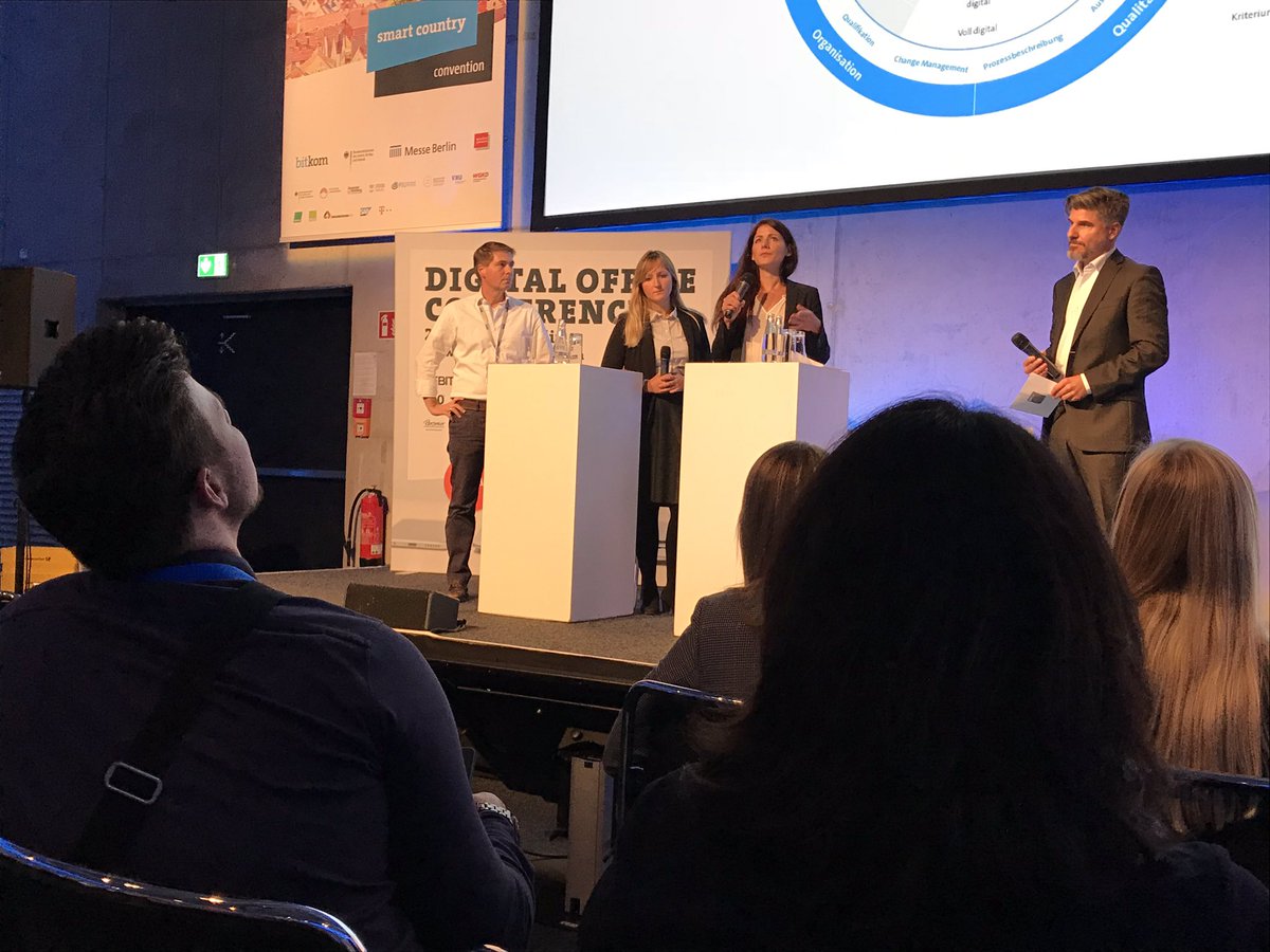 Bitkom_DOffice's tweet photo. “Nur weil ein Prozess digital ist, ist er noch nicht gut”, leitet Dr. Annika Wederhake von der @MACH_AG die Podiumsdiskussion zu Reifegradmodellen Digitale Geschäftsprozesse mit der @postbank und @WKGT_AG auf der #doc18 ein. #SCCON18 https://t.co/l3RLchG6Tt