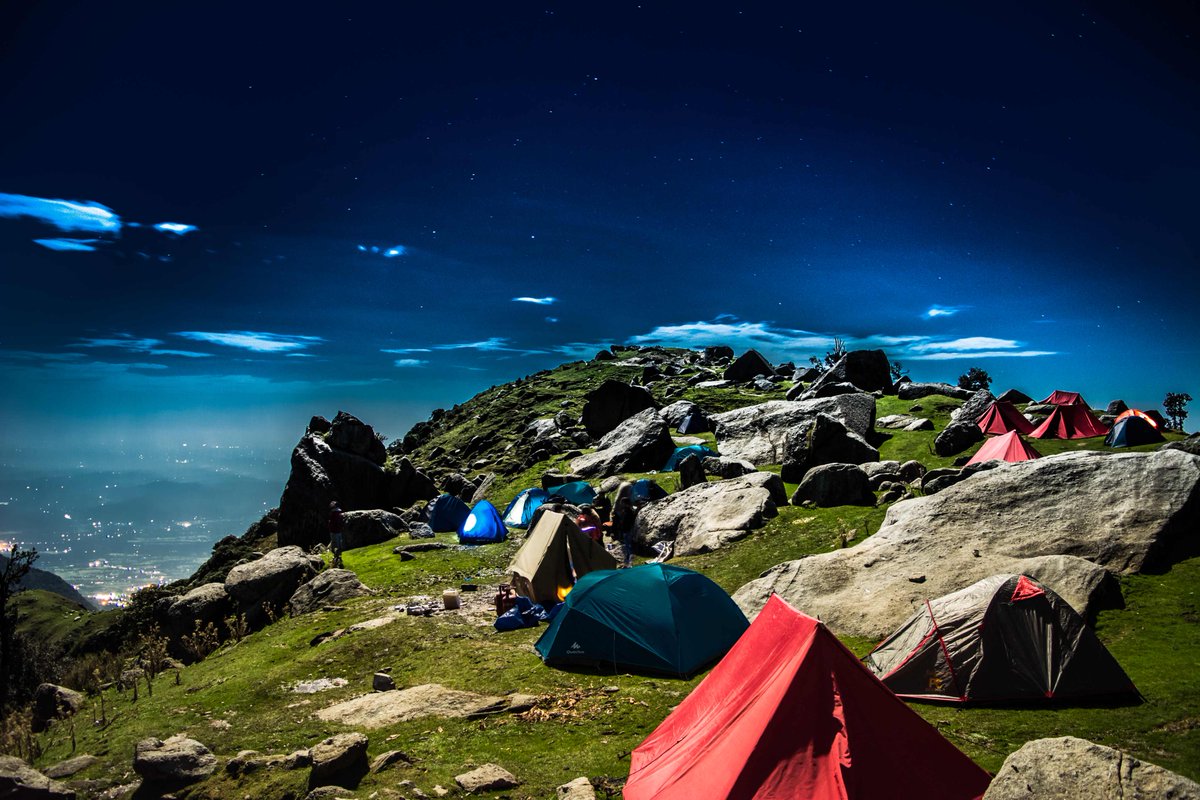 Starting from the charming town of #Mcleodganj in #HimachalPradesh, set your first foot for a gradual #trek to #Triund. Often covered with clouds in the dawn, the snow-capped peaks & slopes of the mountains set the mood right for the adventurous trail ahead. #campinginindia