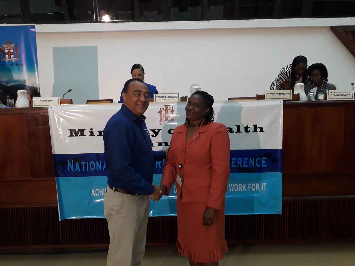themohwgovjm's tweet photo. Minister @christufton congratulates one of the 2018 awardees for the Ministry of Health Research grants at the #NHRC2018. #PublicHealthJa https://t.co/vOsPxX4EDm