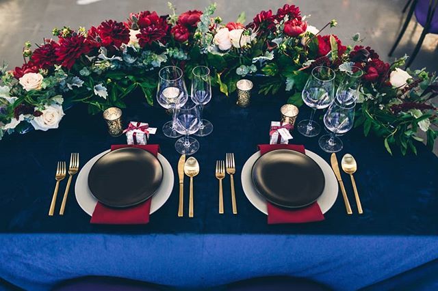 This tablescape is sleek &amp; seasonal, with a small wrapped present at each setting. Mixing berry florals with deep blue velvet linens creates a luxe palette that can be appreciated year round. || Photographer: <a href="/vitaeweddings/">VITAE WEDDINGS</a> | Venue: <a href="/southparkcenter/">South Park Center</a> | Planner: <a href="/therheefined/">Rheefined Company</a> …