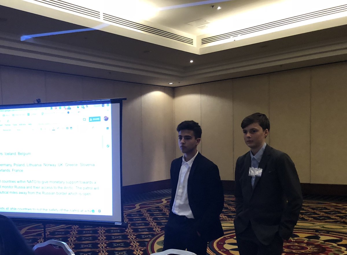 NYmge's tweet photo. NATO delegates of Belgium and Iceland presented Working Paper 1.3. The paper  discusses moving populations to other countries, raising tariffs, researching climate change in Arctic region, and monitoring Russian border on open waters. https://t.co/V2G9exFAFh